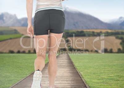 legs Walking or jogging on path towards mountains