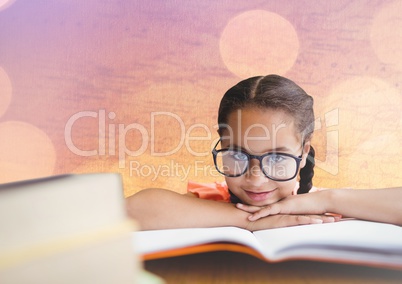 Girl at desk with books against map with bokeh