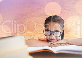 Girl at desk with books against map with bokeh