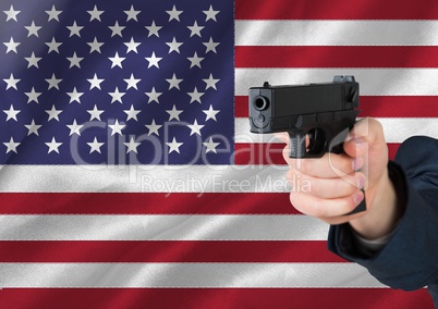 Hand holding gun with American flag