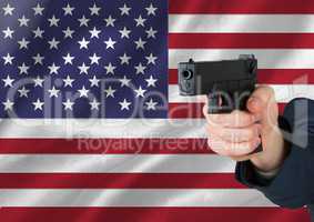 Hand holding gun with American flag