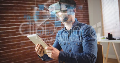 Businessman wearing VR glasses while holding tablet PC