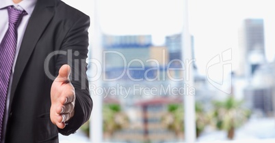 Midsection of businessman offering handshake