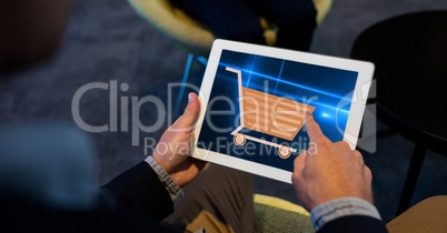 Hand touching shopping cart sign on tablet PC
