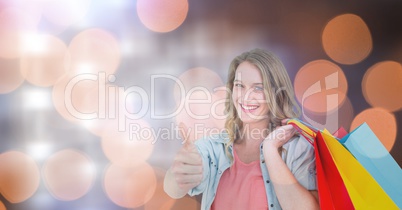 Woman with colorful bags showing thumbs up