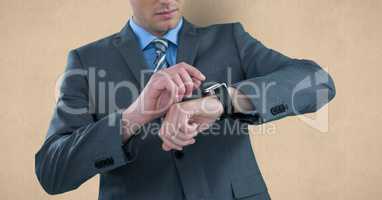 Midsection of businessman checking time