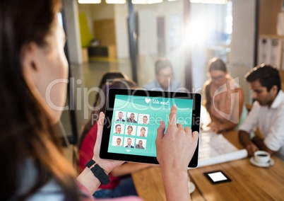 Woman in a meeting with her tablet. Login screen