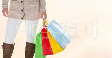 Midsection of woman with colorful shopping bags