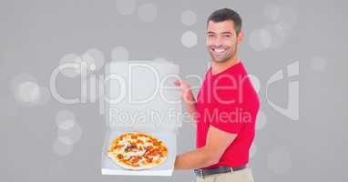 Portrait of smiling delivery man showing pizza in box