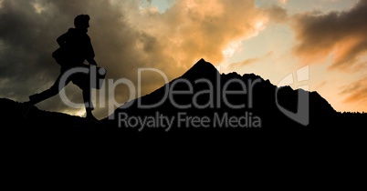 Silhouette businessman running on mountain against sky