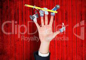 Hand with hands with tools on the fingers. Red wood background
