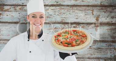 Composite image of smiling female chef with pizza