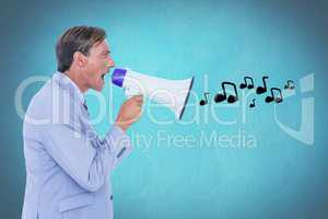 Digitally generated image of businessman shouting on megaphone emitting music icons