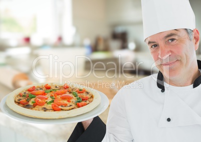 Chef with pizza in the kitchen