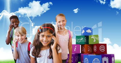 Happy kids using smart phones with apps icons in background