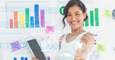 Happy businesswoman holding digital tablet against graphs