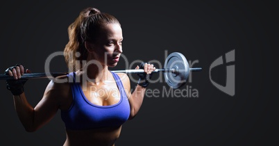 Woman with weights against dark grey background
