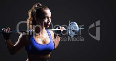 Woman with weights against dark grey background