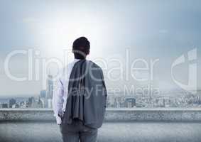 Businessman looking up at sky in city