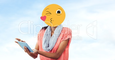Woman with emoji over face using tablet PC