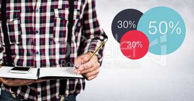 Man mid section with notebook against white wall and colourful statistics