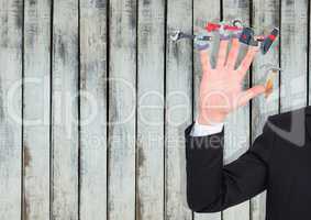 Hand with hands with tools on the fingers. Wood background