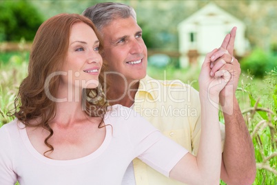 Smiling couple pointing away