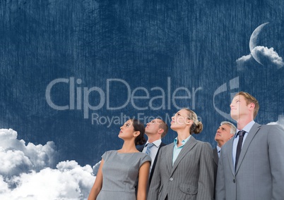 Business people looking up at cloudy sky with moon