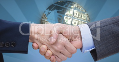 Close-up of handshake with money in background