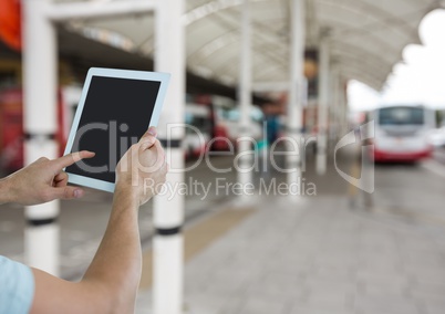 hands with tablet in the bus station