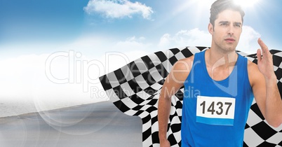 Male runner sprinting on road against sky and sun with flare and checkered flag