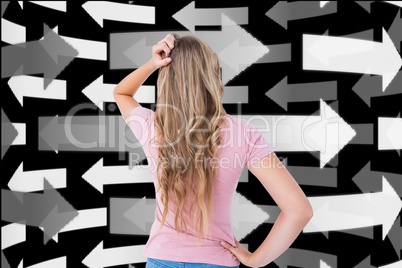 Digitally generated image of confused woman looking at arrows in background