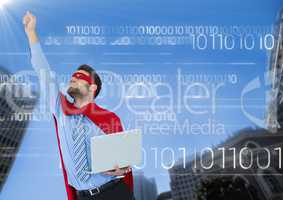 Business man superhero with laptop and hand in air against buildings and sky with white binary code