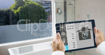 Hands using smart home application on tablet PC