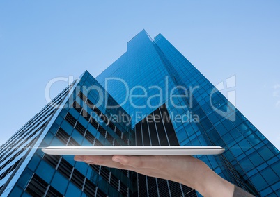 Holding tablet with skyscraper background