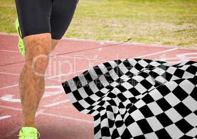 Male runner legs on start line with checkered flag