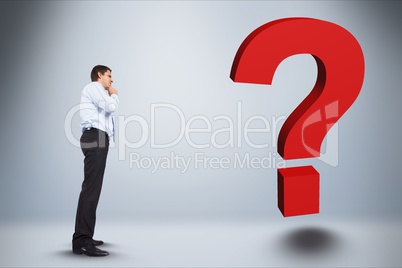 Digital composite image of businessman looking at question mark