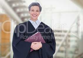 Judge holding book in front of staircase