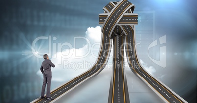 Digital composite image of businessman standing on jumbled highway