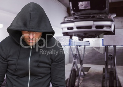 Criminal with hood in car theft mechanics fraud