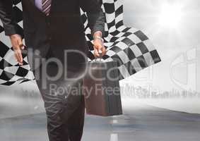 Business man lower body with briefcase on road with skyline and checkered flag