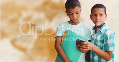 Boys with phone against blurry brown map