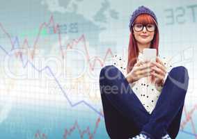 Woman with phone and legs crossed against blue graph