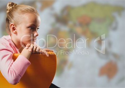 Girl on chair against blurry map