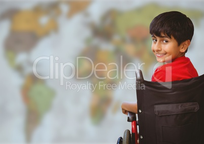 Boy in wheelchair against blurry map
