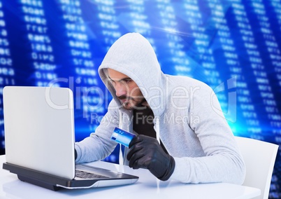 Criminal in hood on laptop with card in front of numbers