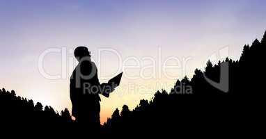 Silhouette businessman by mountains against sky