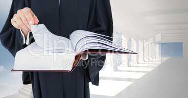 Midsection of judge holding law book