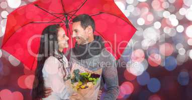 Composite image of happy young couple holding umbrella