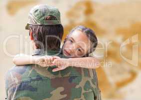 Soldier and daughter against blurry brown map